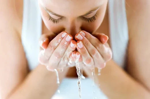 Woman Washing Face - The Benefits of Alkaline Water for Skin Health 