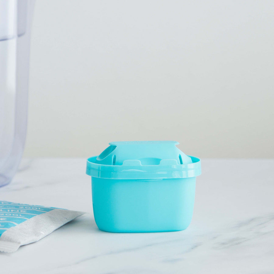 Blue brita maxtra refillable water filter cartridge on marble surface